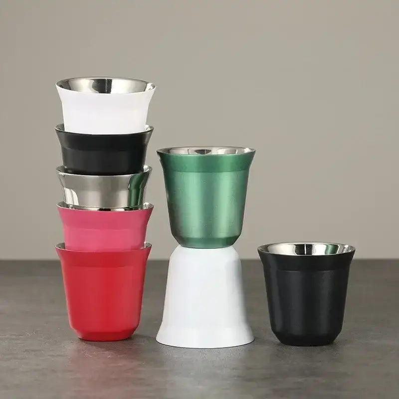 Stack of colorful double wall espresso mugs in pink, red, green, white, and black with glossy metallic finishes