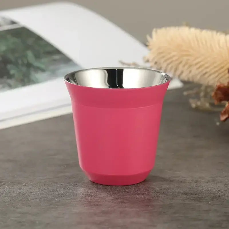 A vibrant pink matte double wall espresso travel mug with stainless steel interior and modern tapered design