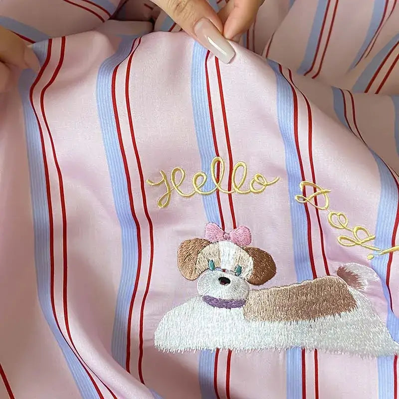 Pink satin pajama top with embroidered dog and gold hello detail from pink and red striped cool lyocell fiber blanket set decorbites cool lyocell