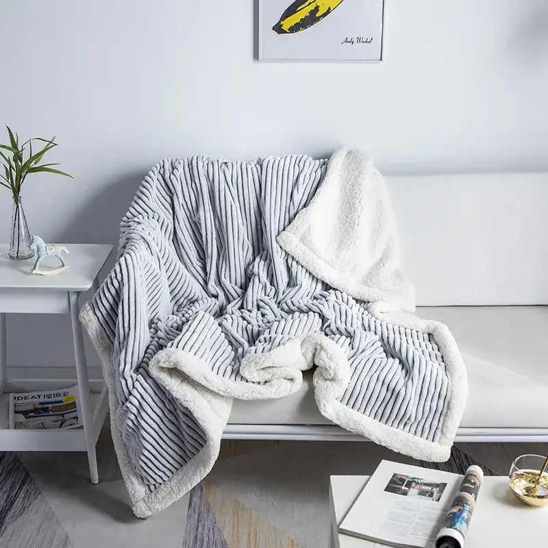 Gray corduroy throw blanket with plush white fleece lining from decorbites cozy nordic wool collection for bedroom use