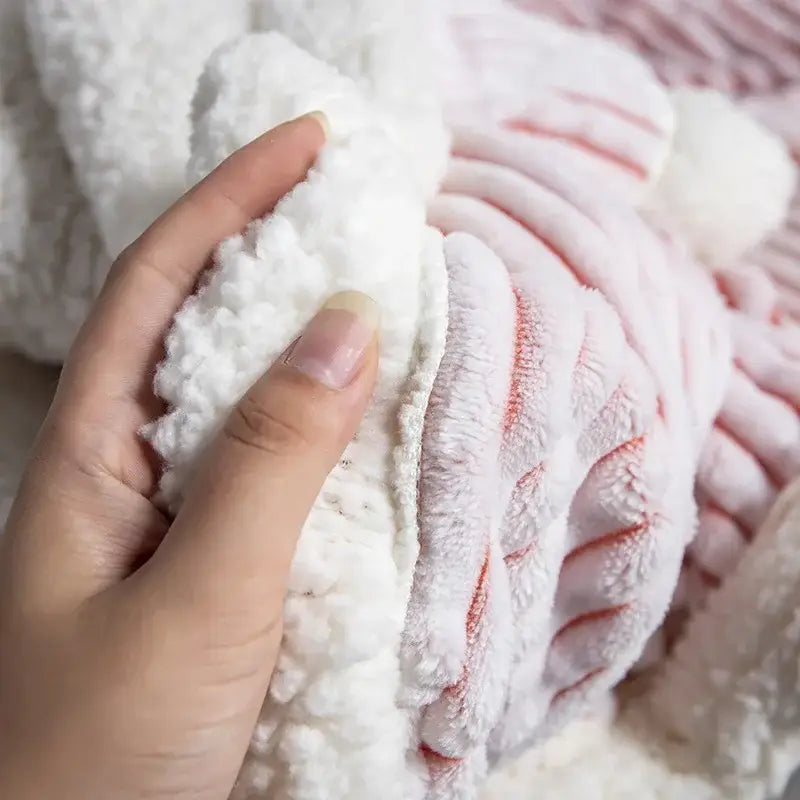 A soft plush white and pink striped throw blanket with cozy nordic wool texture perfect for decorbites cozy nordic decor