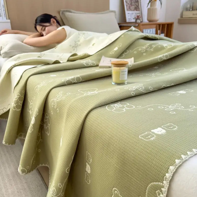Soft sage green decorbites cotton towel blanket with white embroidered bear floral patterns and fringed edge for bedroom use