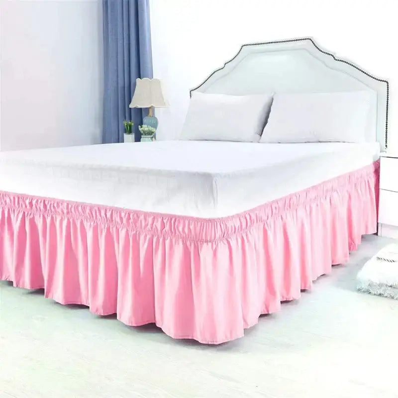 Pink ruffled elastic bed skirt with solid color design and elasticized waistband for soft wrap around bedroom use