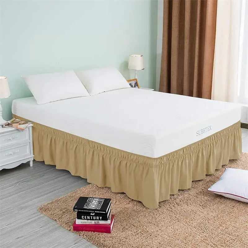 Beige ruffled elastic bed skirt with elasticized hem and surrey branding on mattress cover for bedroom use