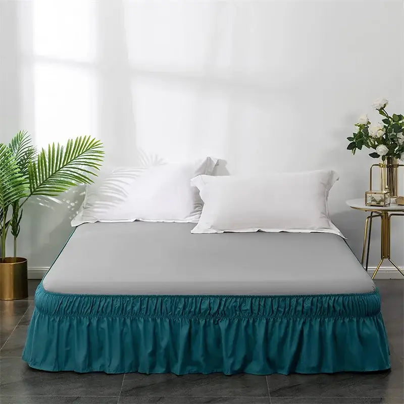 Teal solid color elastic bed skirt with ruffled design and elasticized hem for soft wrap around bedroom use