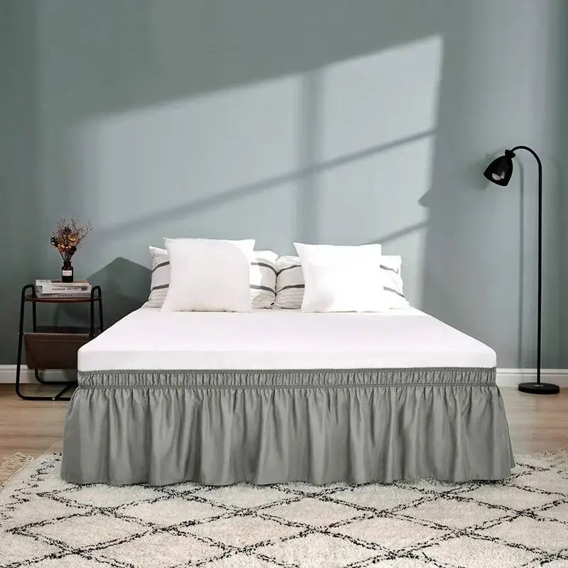 Gray ruffled elastic bed skirt with gathered elastic band at the top for a soft solid color bedroom wrap around