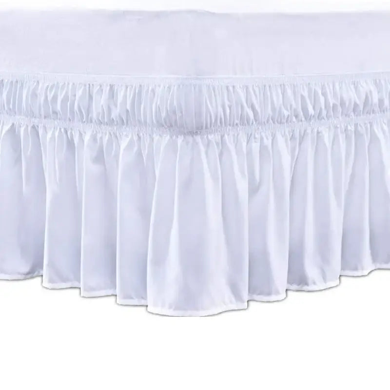 White ruffled elastic bed skirt with elasticized hem in soft wrap around style for bedroom use