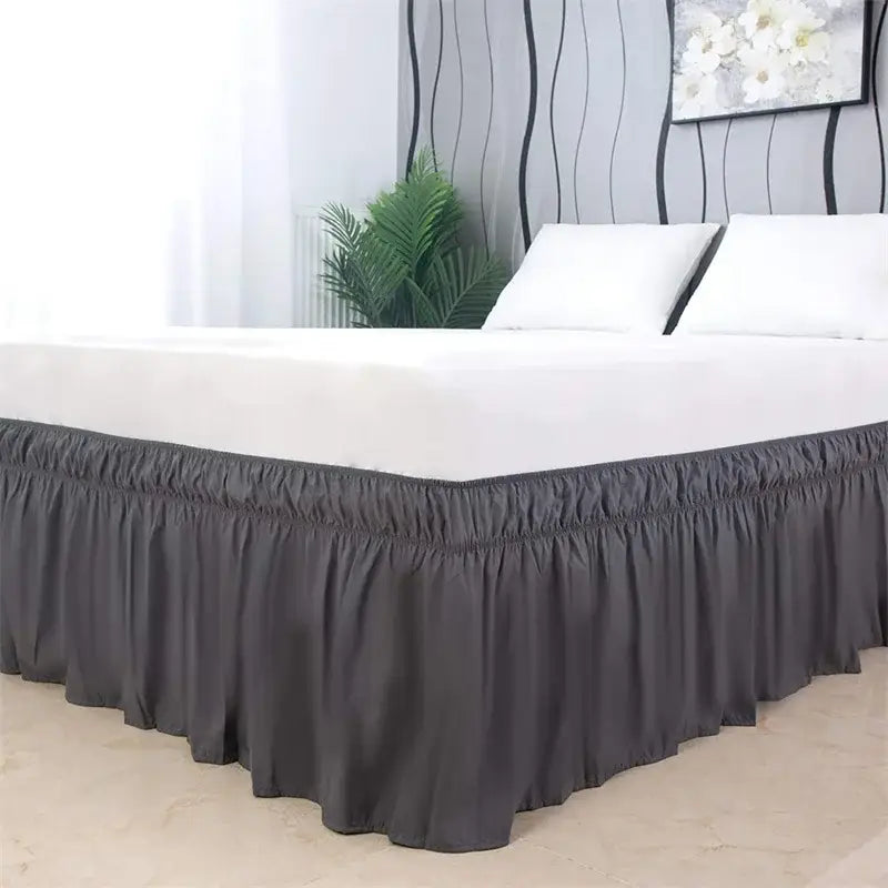 Dark gray ruffled elastic bed skirt with elasticized hem for a soft and solid color bedroom wrap around use