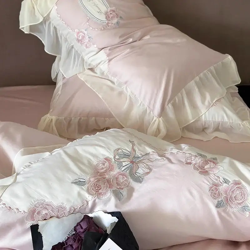 Pink satin egyptian cotton flowers bedding set pillowcases with white ruffles and embroidered rose motifs in soft pink and silver