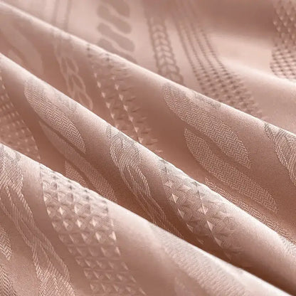 Soft blush pink satin jacquard duvet cover set with intricate woven geometric and leaf motifs and white piping