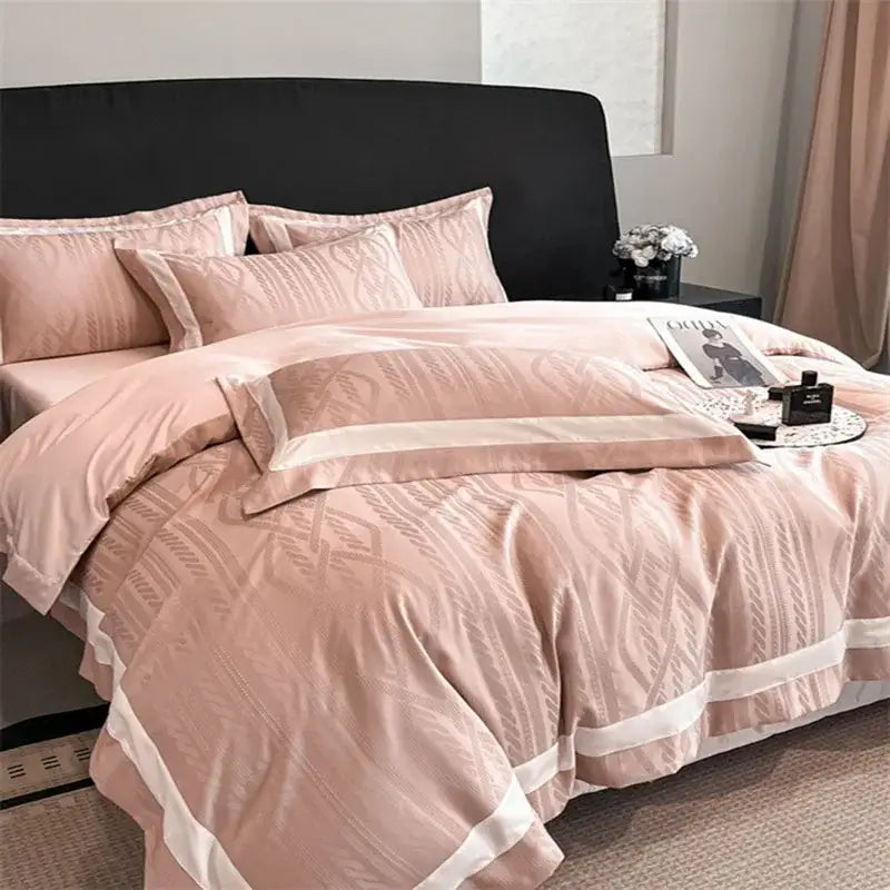 Soft blush pink satin jacquard duvet cover set with subtle geometric pattern and elegant white piping trim