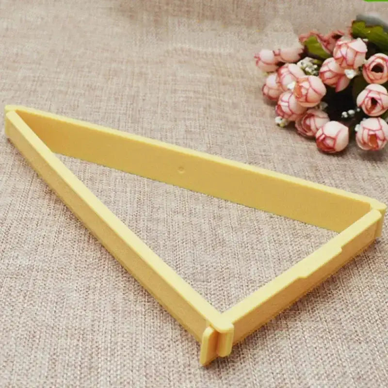 Yellow triangular plastic cookie cutter included with pink silicone decorbites croissant maker kitchen pastry tools