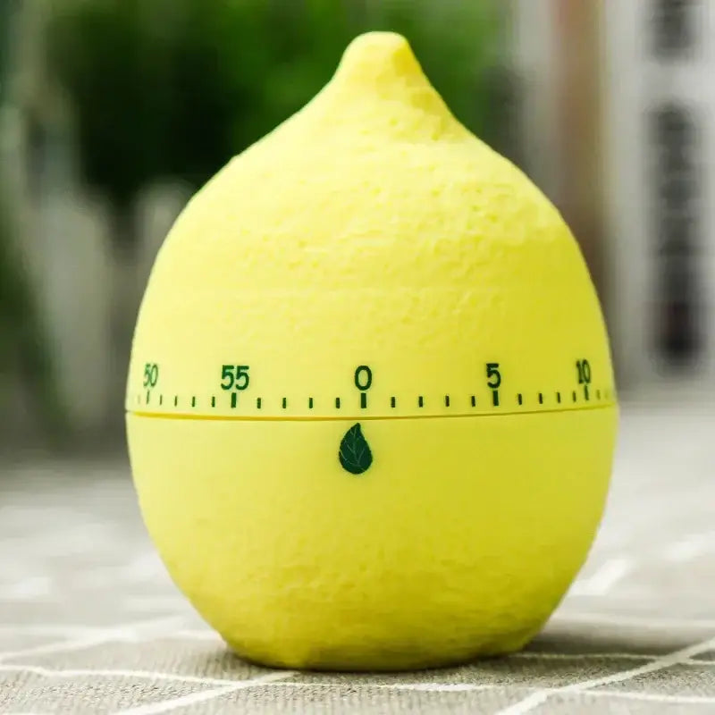 Bright yellow lemon-shaped cake kitchen timer with green numbers and leaf emblem for cute cartoon cake baking use