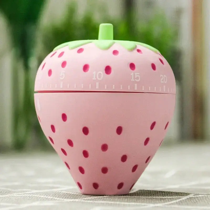 Pink strawberry cartoon cake kitchen timer with green leafy top and red dots for kitchen baking gadget use