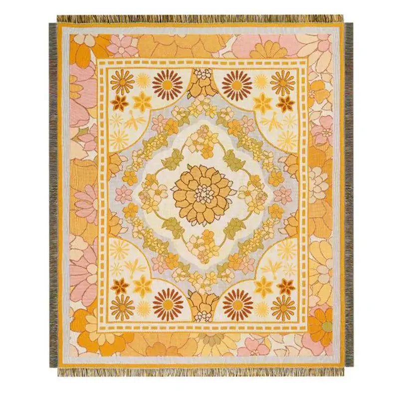A rectangular knitted blanket with vibrant retro floral pattern in yellow orange pink and green featuring fringed tassels decorbites cat strawberry design
