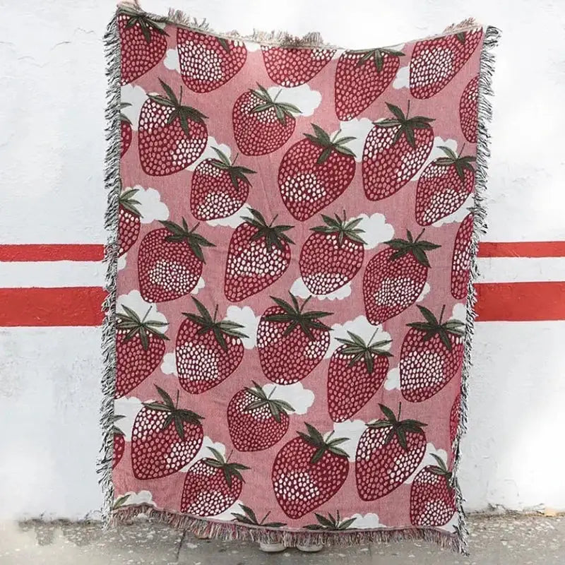 Pink knitted blanket with red strawberry and white cloud pattern featuring fringed tassel edges for bedroom decorbites cat strawberry style