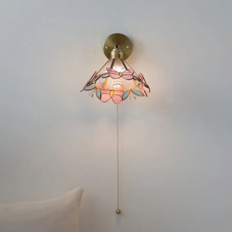 Pink and teal copper butterfly glass wall light with brass finish decorative butterfly-themed bedroom sconce