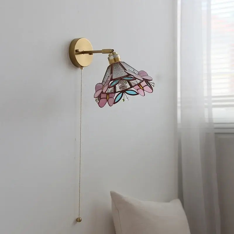 Delicate decorbites copper butterfly wall light with gold-finished metal frame and pink teal copper butterfly glass shade