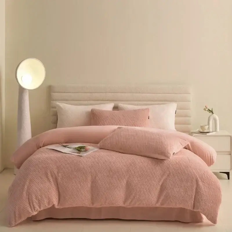 Pink textured winter fleece bedding set with matching pillows and tufted headboard in bedroom decor