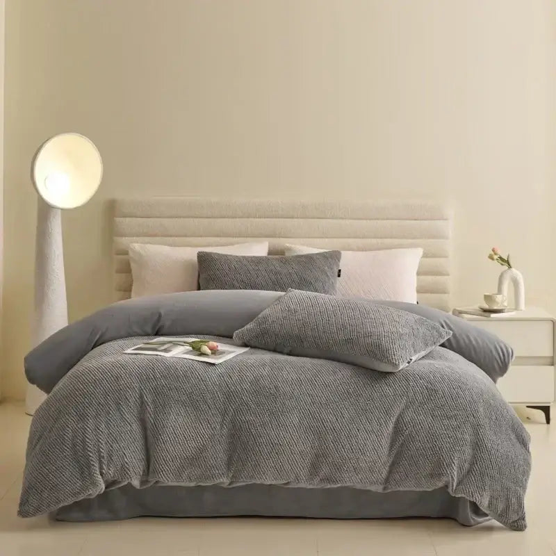 Gray textured duvet cover set with matching pillows in a winter fleece bedding set for cozy bedrooms