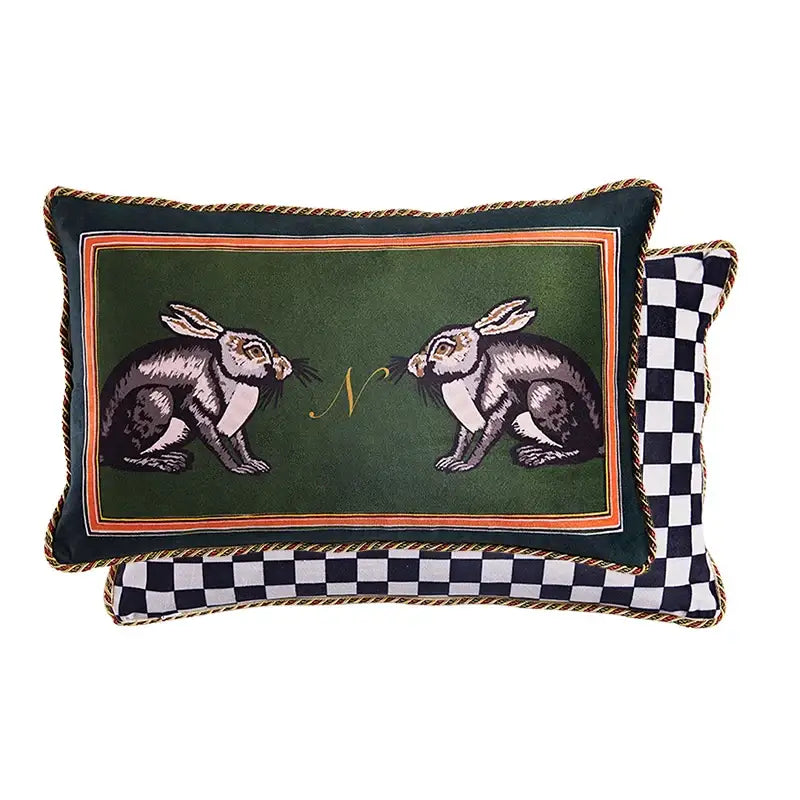 Deep green velvet cushion cover with embroidered rabbits, gold monogram, orange border, and braided trim for living room