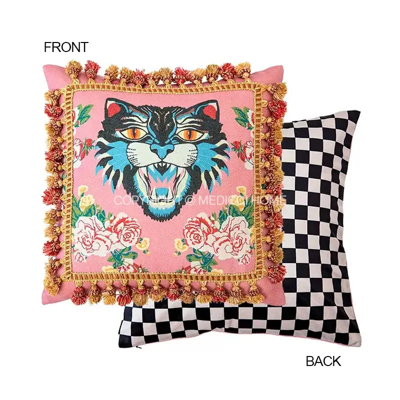 Pink velvet cushion cover with vibrant embroidered blue and black cat print featuring orange eyes and gold tassels