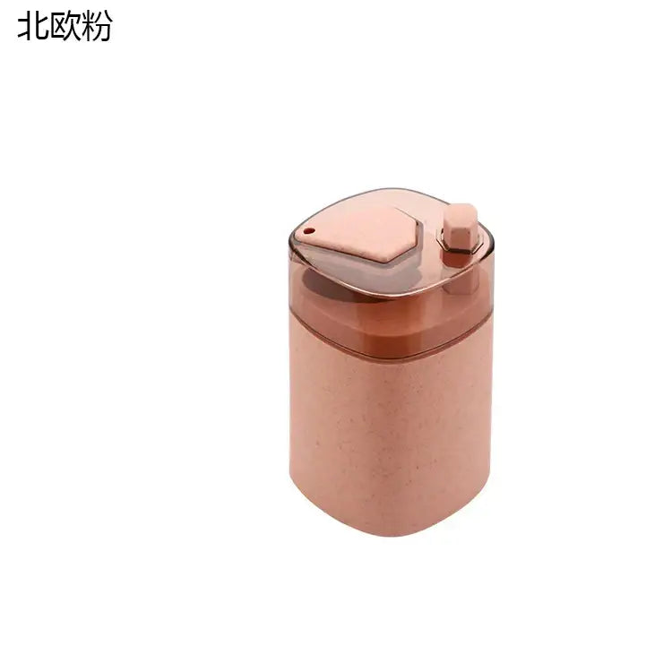 Pink and translucent automatic toothpick dispenser holder in rose gold with a hexagonal lid and textured body dispenser holder