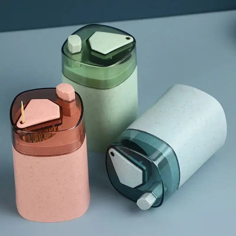 Pink automatic toothpick dispenser holder with translucent brown lid and geometric design for kitchen storage