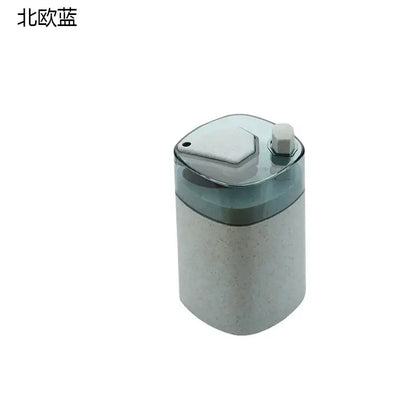 A translucent blue automatic toothpick dispenser holder with a speckled gray body and a hexagonal white cap