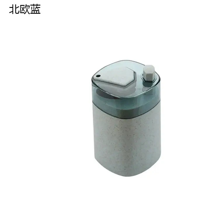 A translucent blue automatic toothpick dispenser holder with a speckled gray body and a hexagonal white cap
