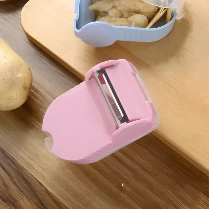 Pink translucent afralia snail peeler with metallic blade for kitchen vegetable peeling tool