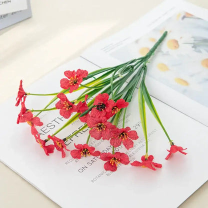 A vibrant red artificial cherry flower bouquet with delicate petals and green stems for cherry blossom wall decor