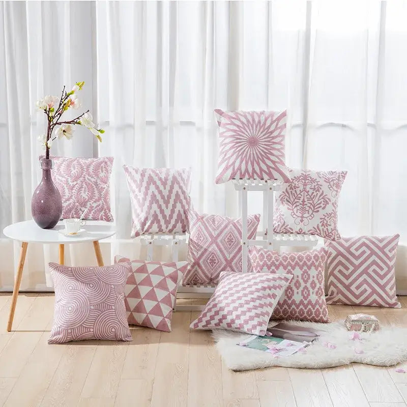 A collection of pink and white decorbites cotton flower embroidered geometry pillows for living room decor
