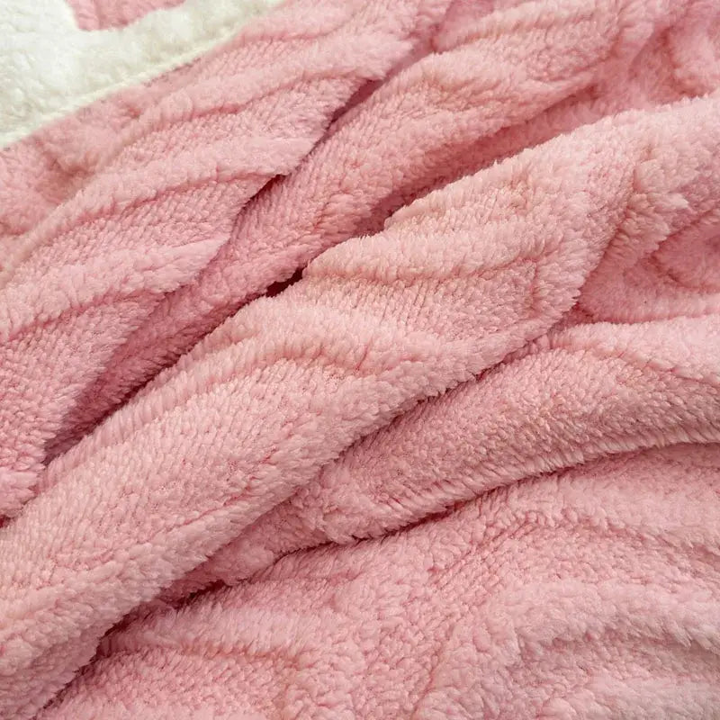 Soft pink plush blanket with double layered flannel and subtle white trim in a layered flannel arch design