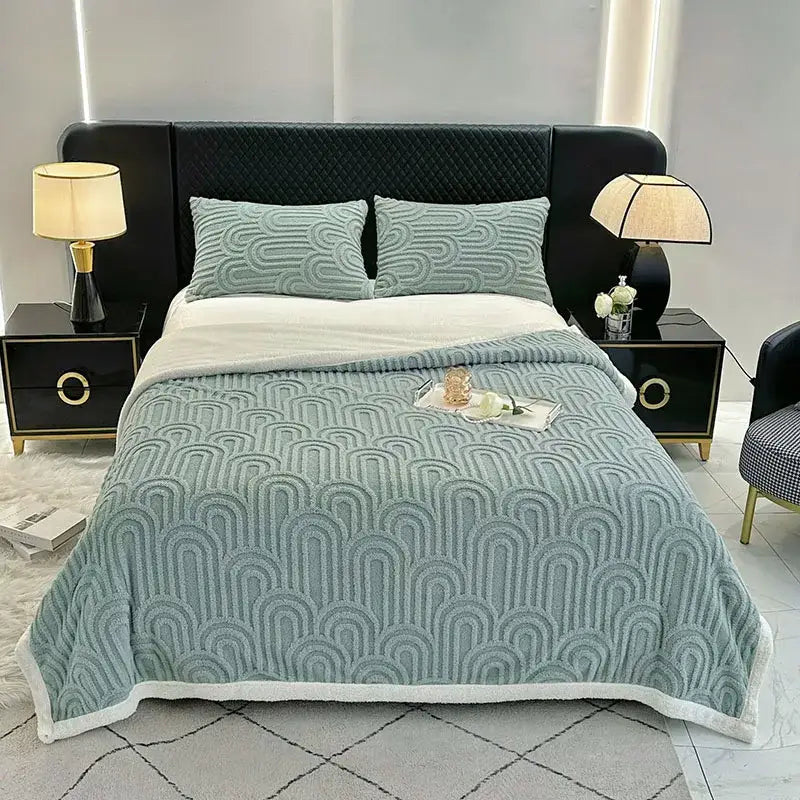 A soft light blue plush blanket with a wave pattern and white fleece trim double layered flannel arch design