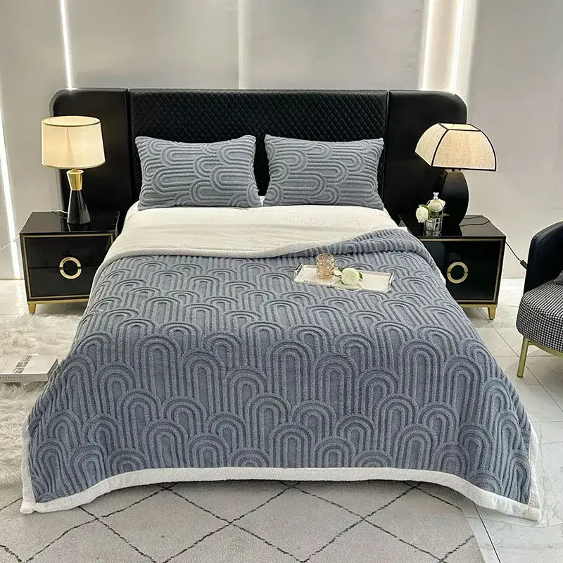 Gray quilted bedroom quilt with white fleece trim featuring a layered flannel arch plush blanket design