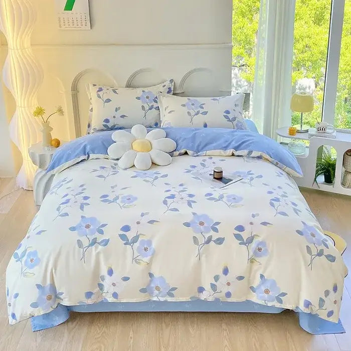 Cream-colored cotton printed bedding set with blue floral decorbites cotton printed design and plush daisy pillow centerpiece