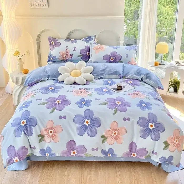 Light blue decorbites cotton printed bedding set with purple pink blossoms green leaves and small bow details satin finish