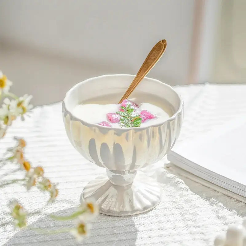 A delicate white ceramic dessert bowl with gradient gloss finish filled with creamy yogurt and pink cube garnish