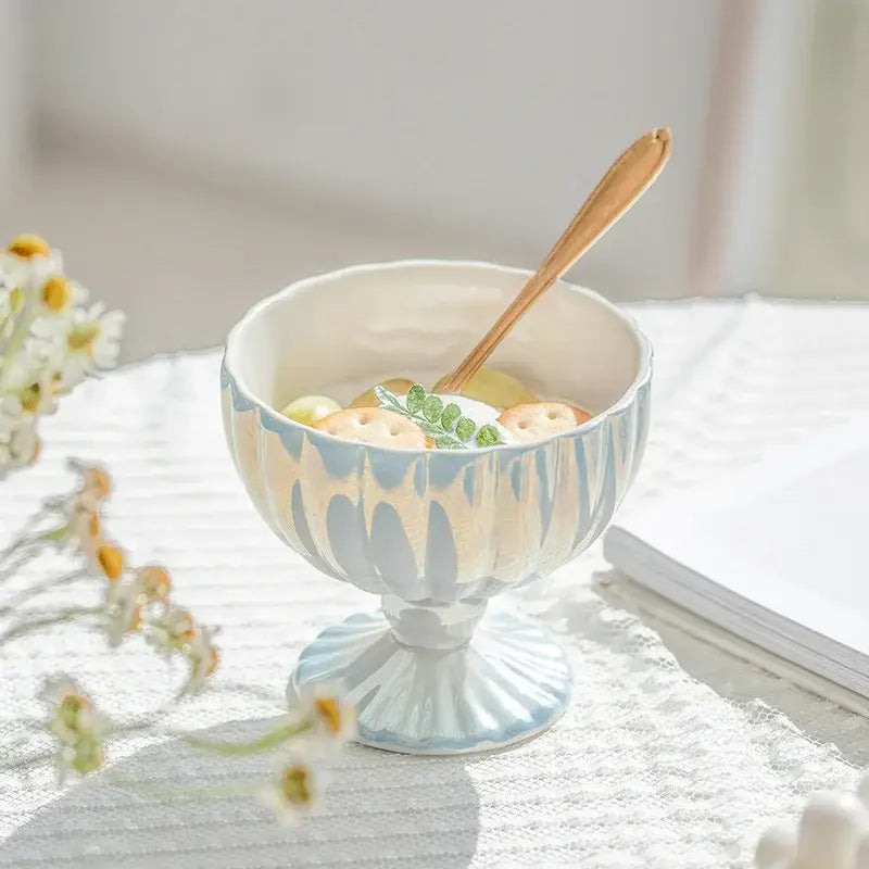 Delicate light blue gradient gloss ceramic dessert bowl with fluted rim and pedestal base holding pastries with mint leaves