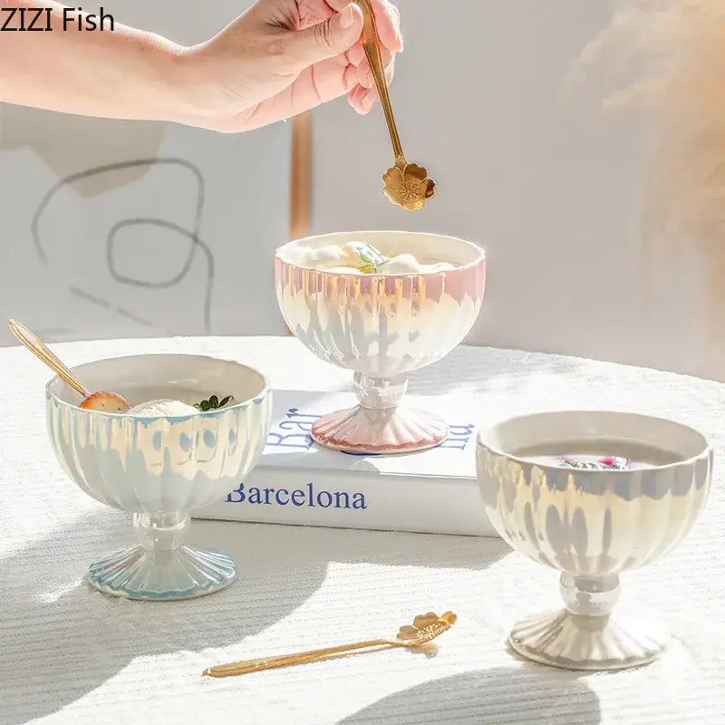 Gold flower-shaped dessert spoon held above pink and white gradient gloss ceramic dessert bowl decorbites gradient gloss
