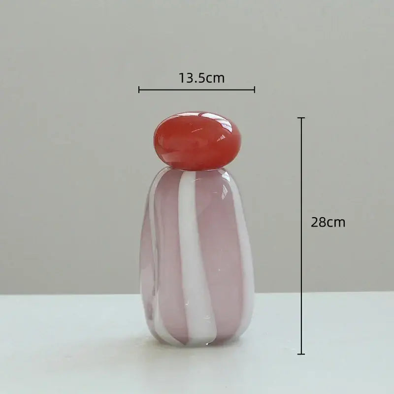 Translucent pink and white striped glass vase cover band with a glossy red rounded stopper for living room decor