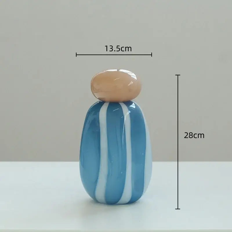 A glossy blue and white striped ceramic vase with a smooth beige lid featuring a vase cover band for living room decor