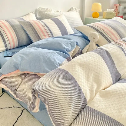 Soft pastel blue and striped bedding set with plush white teddy bear featuring decorbites jacquard cotton bedding