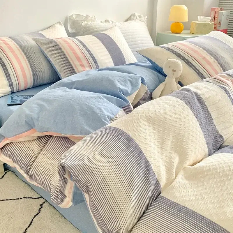 Soft pastel blue and striped bedding set with plush white teddy bear featuring decorbites jacquard cotton bedding