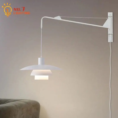 White minimalist wall lamp with swing arm and tiered shade featuring wind rotating mechanism for bedroom use