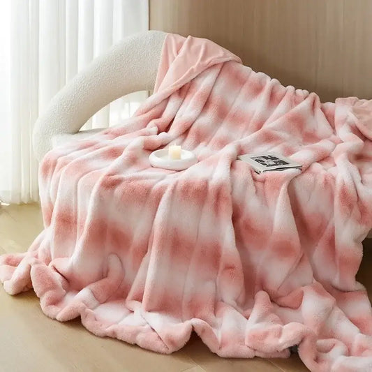 A plush pink and white tie-dye decorbites cozy fleece blanket with a soft fuzzy texture for bedroom use
