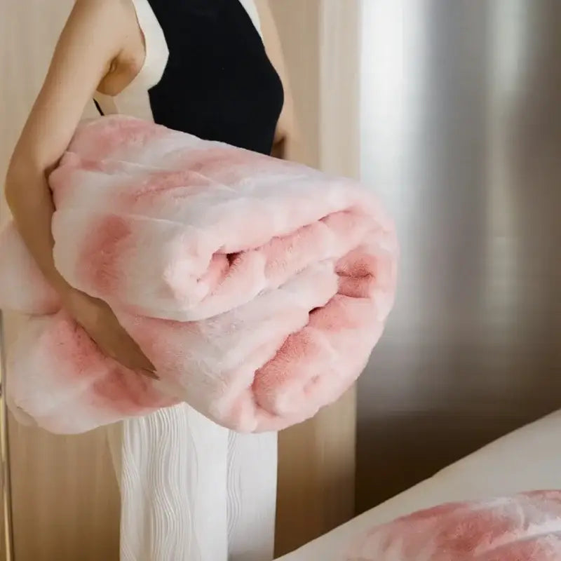 A plush pink and white tie-dye decorbites cozy fleece blanket with soft fluffy texture for bedroom use