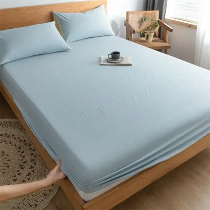 Light blue soft textured cotton fitted sheet with subtle sheen complementing plaid green and beige decorbites cotton fitted design