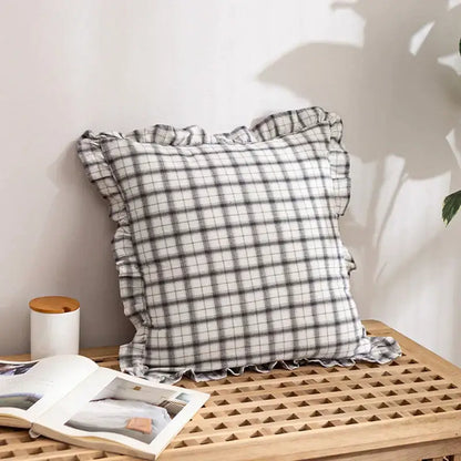 A soft black and white checkered cotton coffee black cushion cover with delicate ruffled edges for living room decor